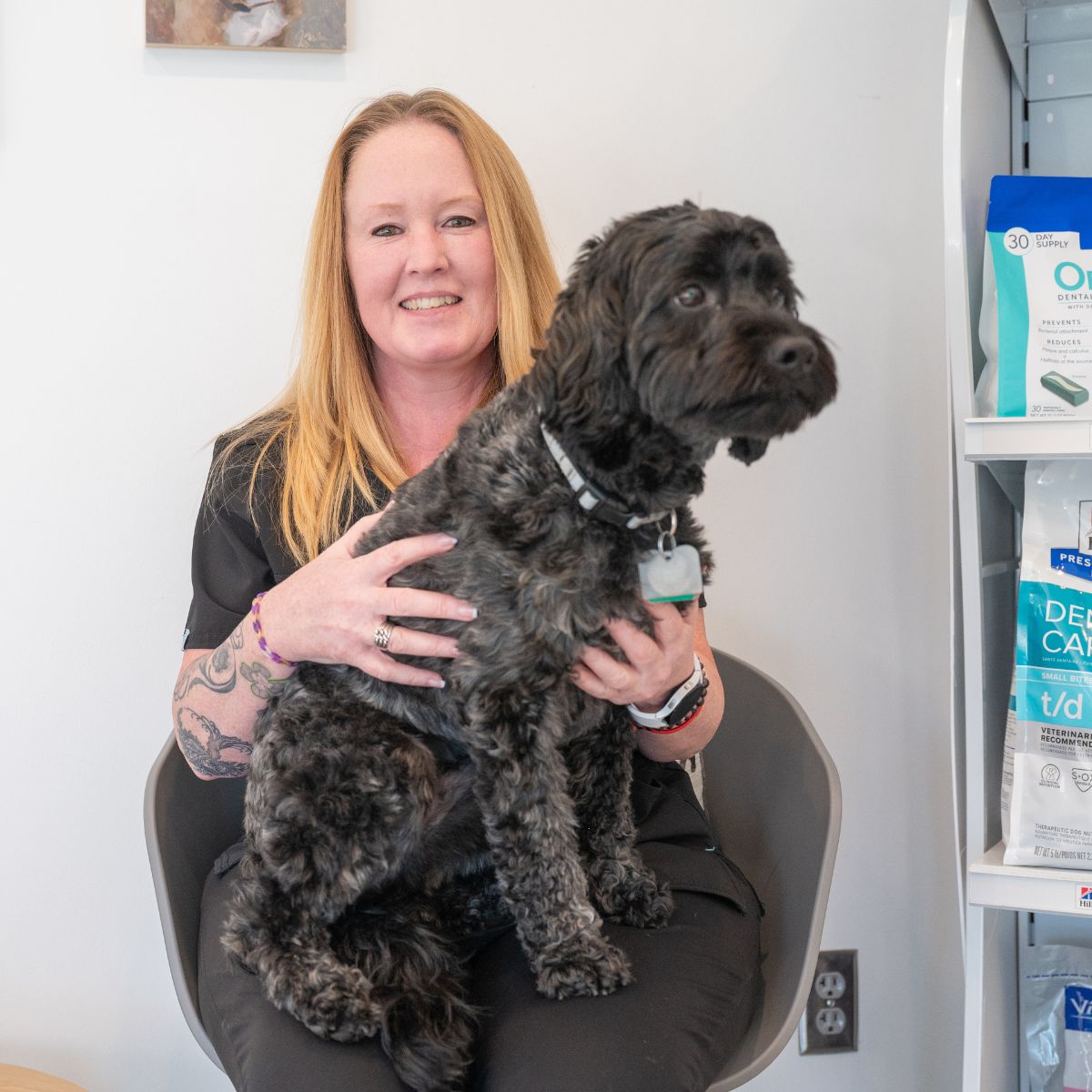 veterinarian carrying a dog on her lap